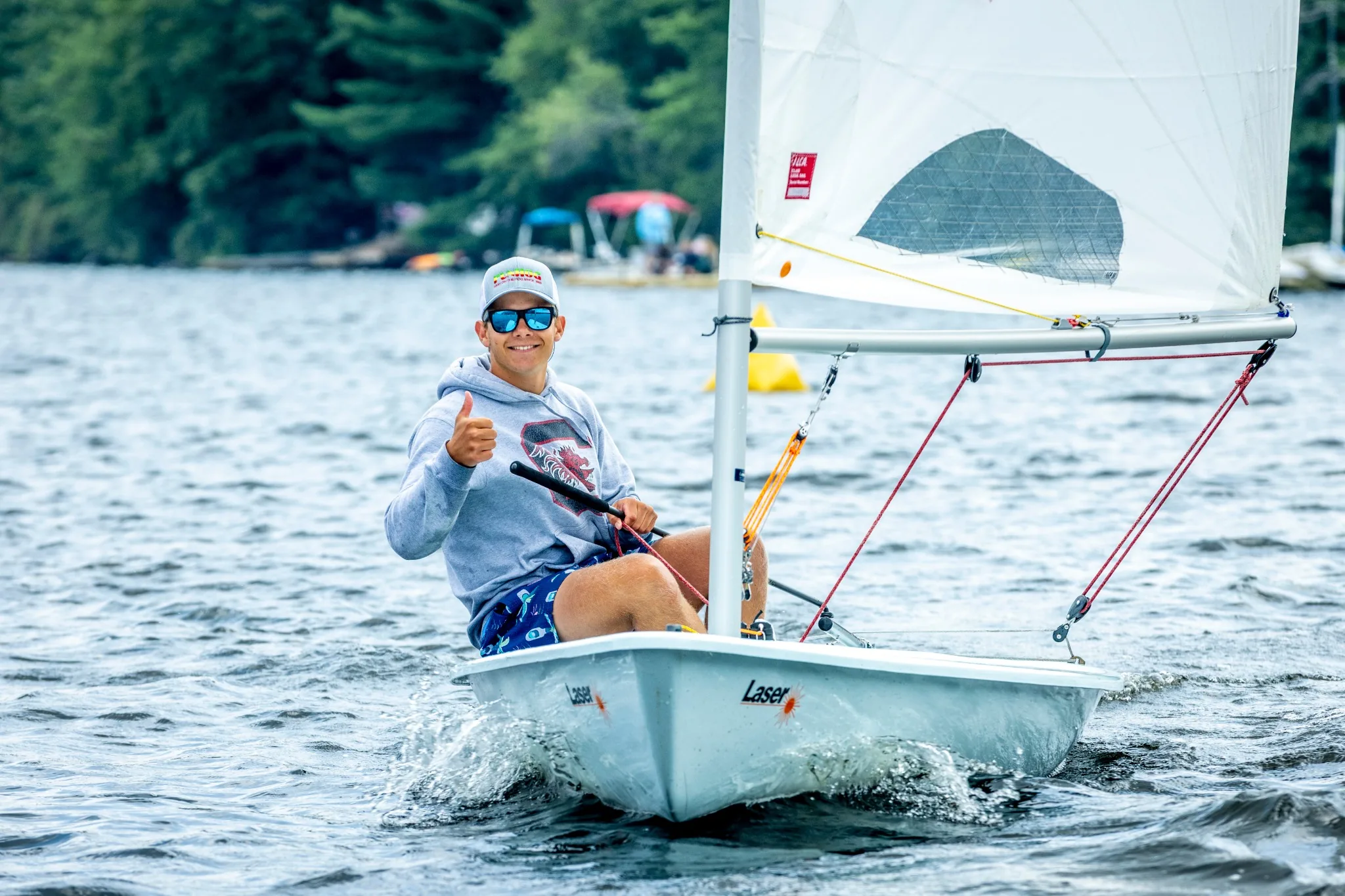 Sailor giving a thumbs-up on the water