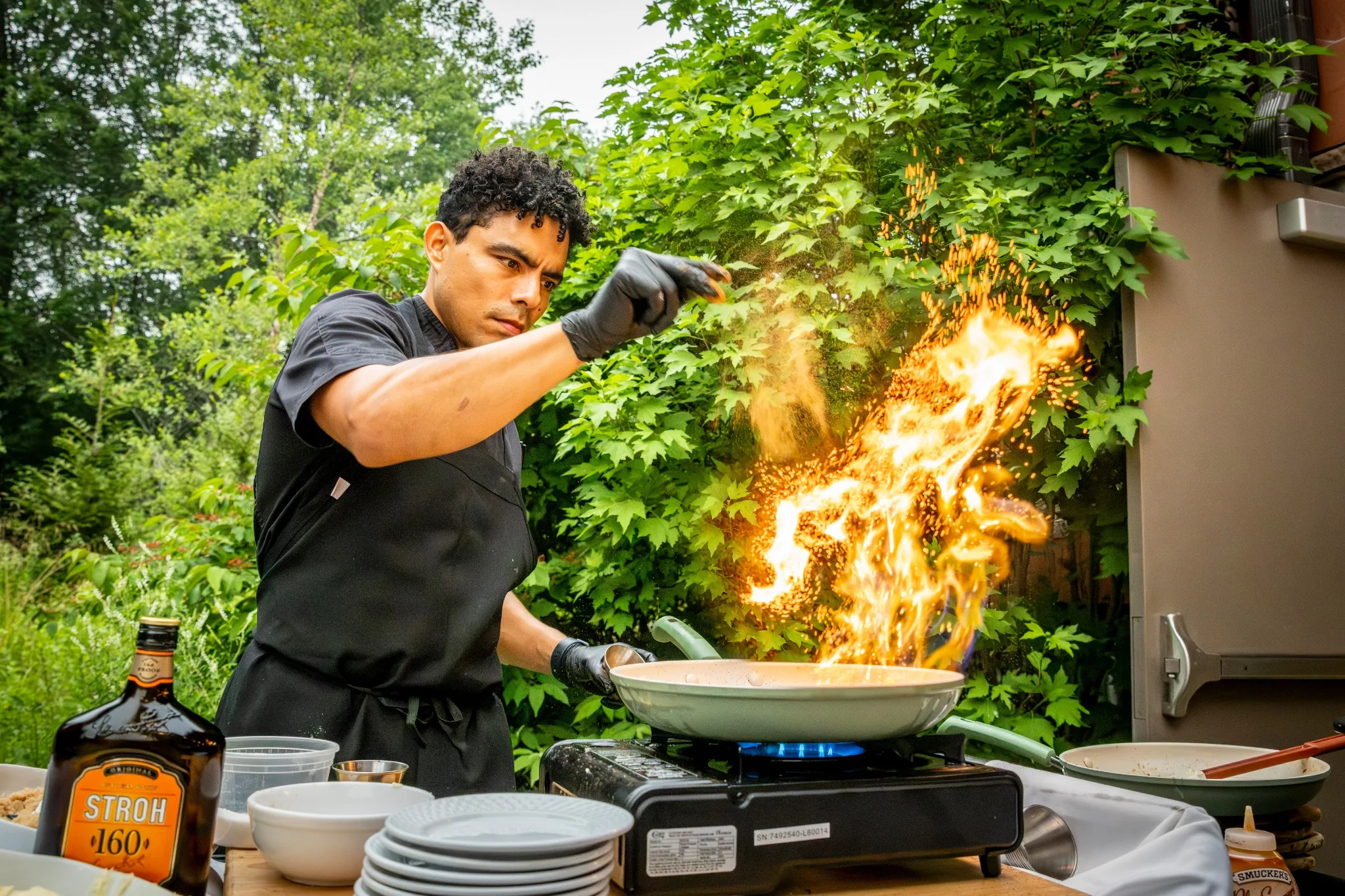 Chef cooking with an open flame during a Lake Naomi event